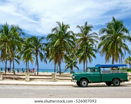Truck converted under the bus parked on the beach. Sunny afternoon in Cuba.