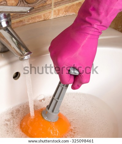 Hand cleaning sewers with cup plunger