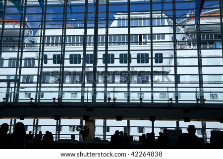Cruise ship seen through windows of terminal