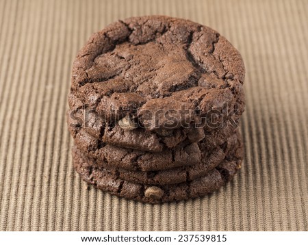 A stack of chocolate chip cookies on a table mat