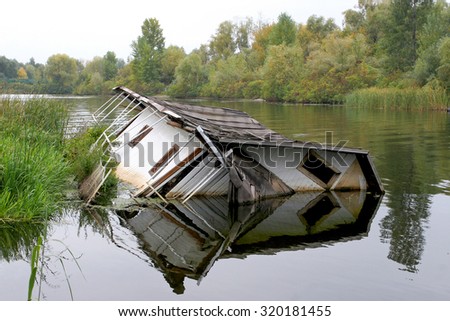 House drowning in the river. The concept  agency real estate insurance.