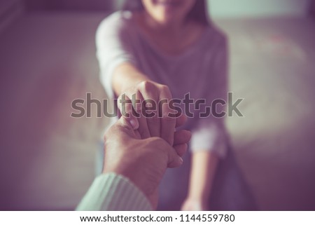 Man giving hand to depressed woman,Psychiatrist holding hands patient,Mental health care concept
