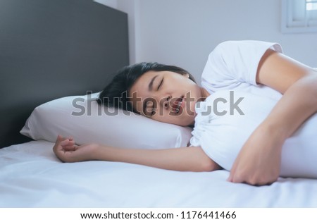 Women sleeping on the bed and grinding teeth,Female tiredness and stress