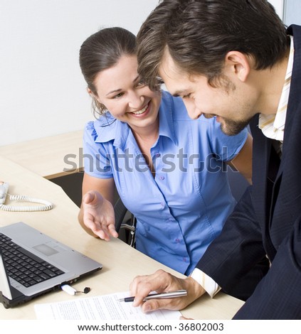 Business couple working with papers and laptop