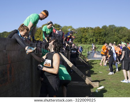 HAMPSHIRE, UK - SEPTEMBER 26, 2015: Tough Mudder is a team-oriented 18-20 km obstacle course testing strength and mental grit. It is not a timed race but a team challenge with world-class obstacles.