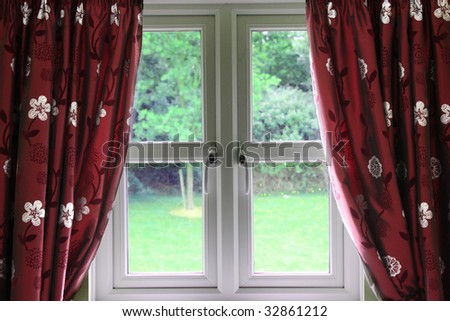 Window draped in silky open curtains