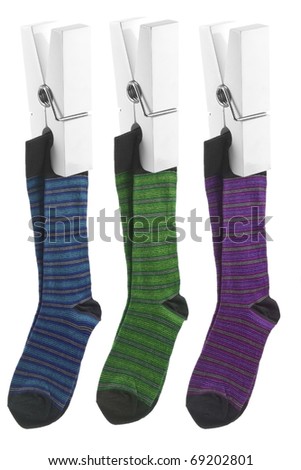 White pegs holding up striped socks