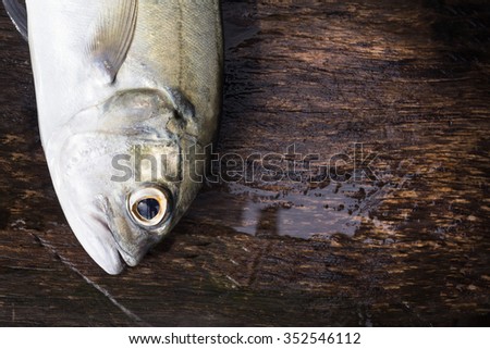 Fish on wooden background,Dusky jack fish,Caranx Sexfasciatus fish,sea fish,sea food