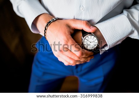 Man checking the time on his wrist watch
