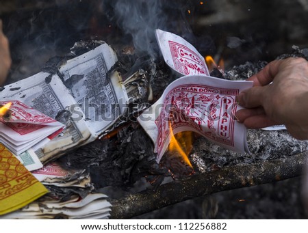 Bundles of money are burned to please the spirits.