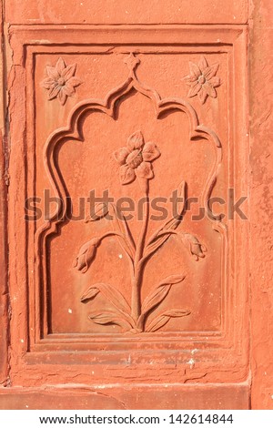 Double framed flower carved in red sandstone at Red Fort's Drum House in Delhi.