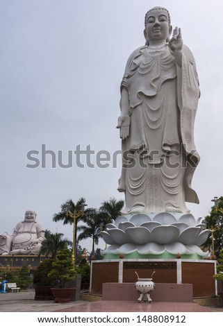 Combination shot of Amitabha statue with Buddha in background. Vietnam, Mekong Delta: huge statues in the garden of the Vinh Trang Pagoda in My Tho.