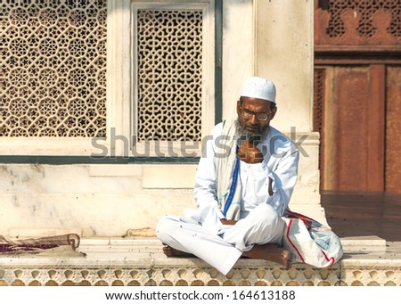 FATHEPUR SIKRI, INDIA - CIRCA FEBRUARY 2011 - Sufi Muslim Cleric studies texts outside the Jama Mashid Mosque in Fatehpur Sikri.