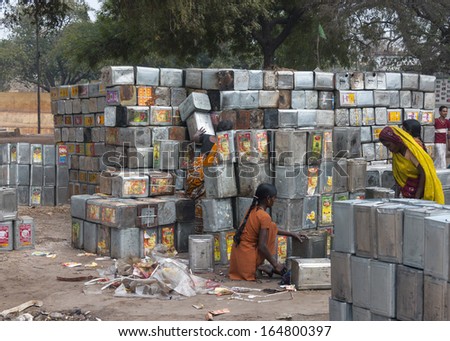 VARANASI, INDIA - CIRCA FEBRUARY 2011: Recycling operation of empty metal cooking oil cans.