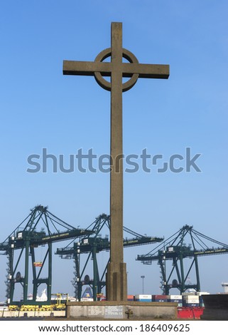 BRUGES, BELGIUM - CIRCA MARCH 2014: Fischermen\'s cross at the port of Zeebrugge-Seabruges with container cranes in the background.
