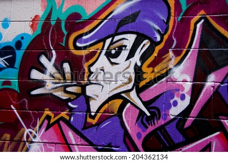 MELBOURNE, AUSTRALIA - CIRCA NOVEMBER 2009: Colorful graffiti in back alley of downtown, depicts an angry looking, cigarette smoking, young man with purple hat.