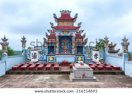 QUANG BINH, VIETNAM - CIRCA MARCH 2012: Monumental shrine fronted by small tombs form the family plot at cemetery.