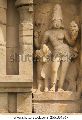 KUMBAKONAM, INDIA - OCTOBER 11, 2013: Ardhanareeswarar, the dual gender Lord Shiva on the outside wall of the Gangaikunda Temple. Expression of completeness covering the female and the male.
