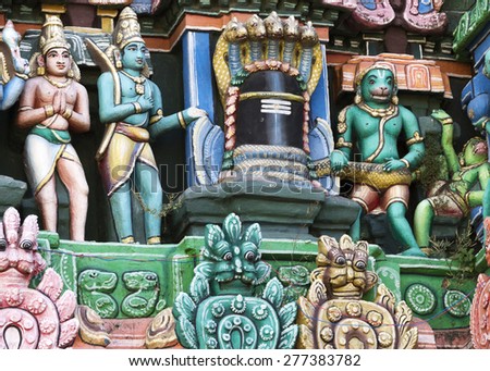 KUMBAKONAM, INDIA - OCTOBER 13, 2013: Kumbeswarar Temple Gopuram. Main actors out of the Ramayana epic around the Shivalingam. The blue Lord Rama and Lakshmana. Hanuman and the defeated green Vali.