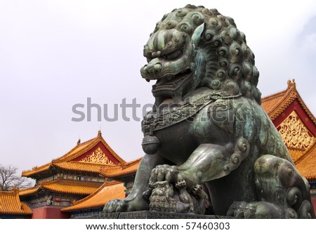 Beijing Forbidden City: lion statue against the roofs.