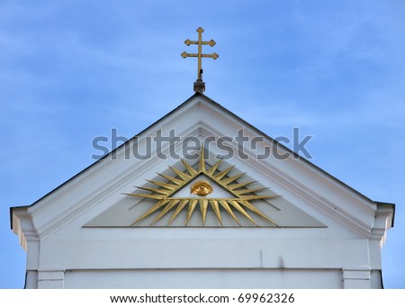 God\'s eye watching from the top of a facade in Plzen.