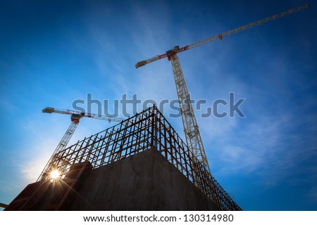 Construction site with cranes on sky background