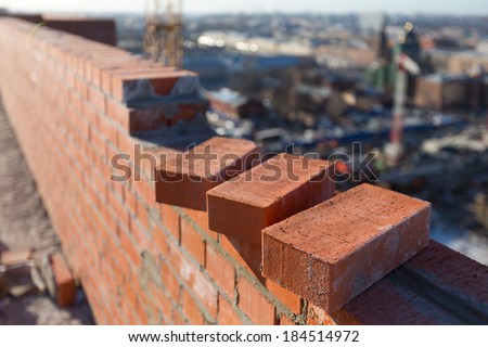 Brickwork in the new house with three bricks in the foreground