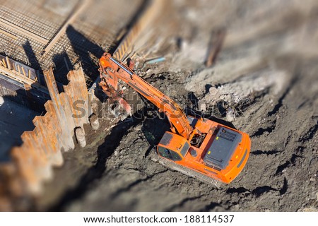 Excavator digs a hole for home designs