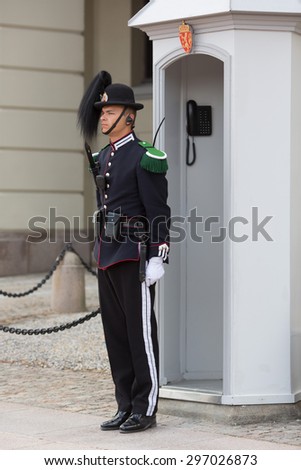 OSLO,NORWAY - JUNE 14: Royal Guard guarding Royal Palace on June 14, 2015 in Oslo, Norway.His Majesty the King\'s Guard keeps The Royal Palace and the Royal Family guarded for 24 hours a day