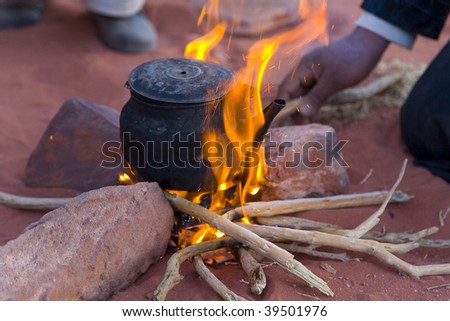 Tea preparation on fire in desert