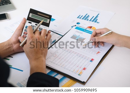 Asian business adviser meeting to analyze and discuss the situation on the financial report in the meeting room.Investment Consultant,Financial Consultant,Financial advisor and accounting concept
