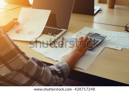 Asian Business woman using a calculator to calculate the numbers vintage tone