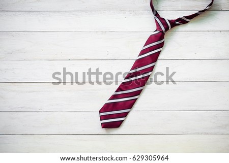 Happy Father\'s Day inscription with colorful tie on wooden background floor background.