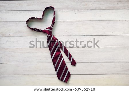 Happy Father\'s Day inscription with colorful tie and watch on wooden background floor background.