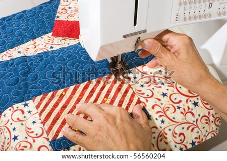 Woman sewing pocket on front panel of tote bag.