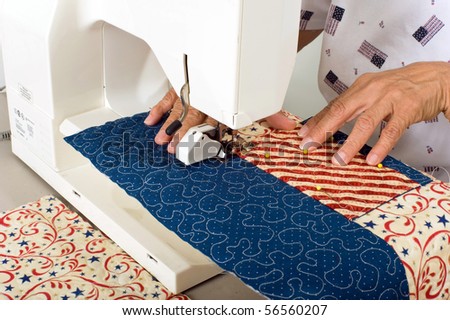 A woman sewing a pocket on front panel of tote bag.