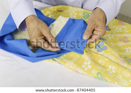 A woman turns pillow case right side out and shows finished seams, no raw edges.