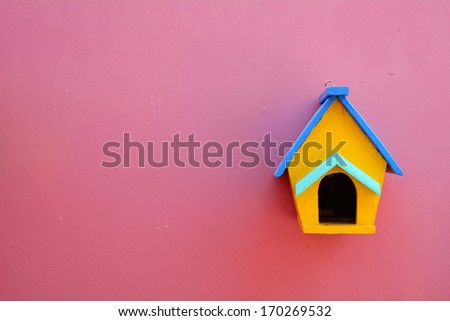 Decorative nesting wood box on violet wall background