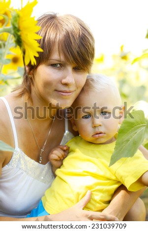 Mom with a little boy in sunflowers