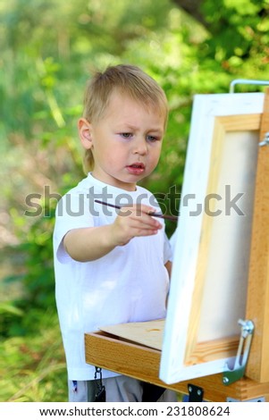 little boy drawing on nature