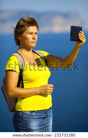 woman with tablet computer on the beautiful coast