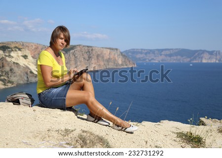 woman with tablet computer on the beautiful coast