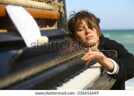 pensive woman at the old piano