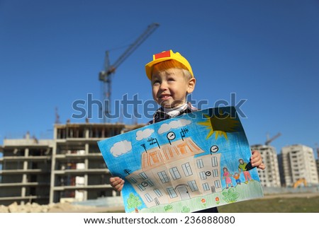 funny boy with a picture of the future house