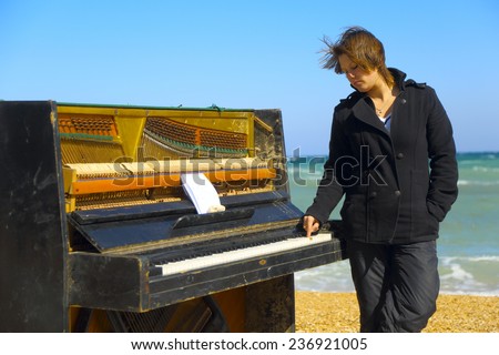 pensive woman at the old piano