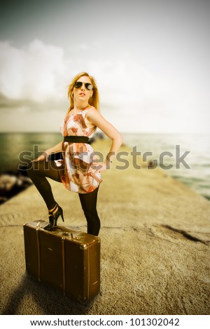 Beautiful blond woman waiting on landing-stage, concept of travel