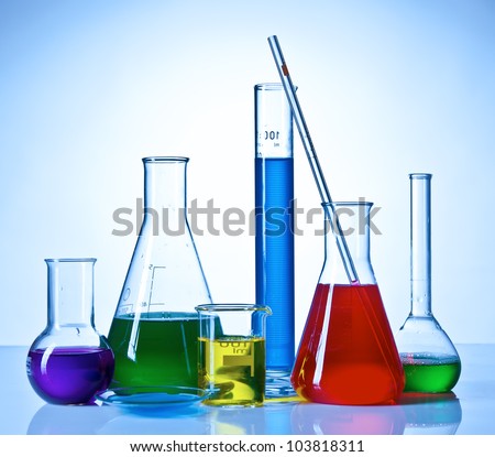 Chemical glassware with colored liquids inside bottles