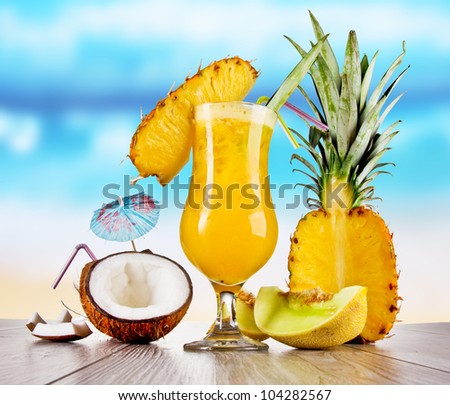 Pina colada drink with blur beach on background