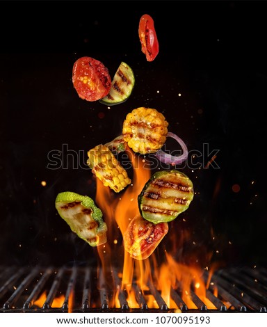 Flying pieces of vegetable from grill grid, isolated on black background. Concept of flying food, very high resolution image