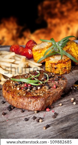 Delicious beef steak with vegetable on wooden table